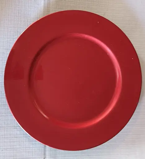 A red charger plate