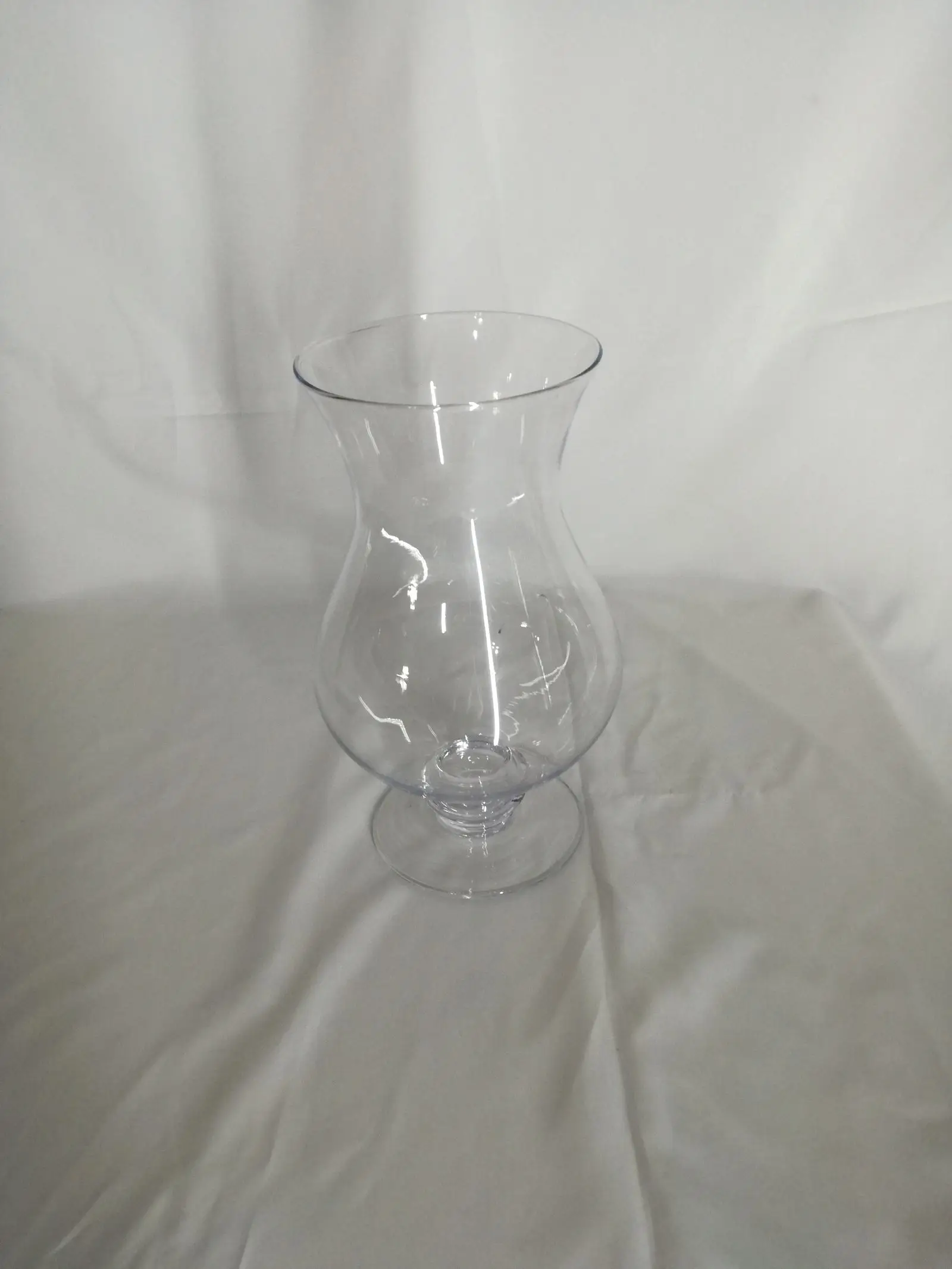 A glass hurricane vase