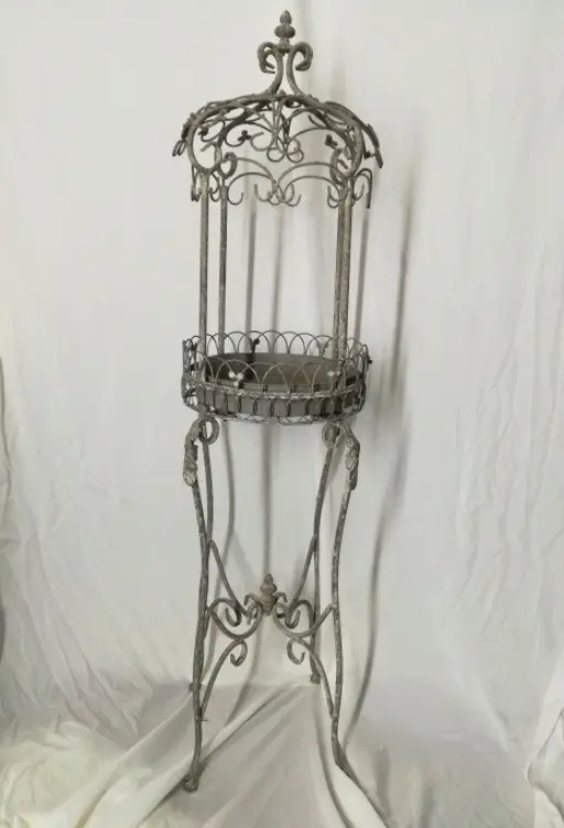 A tall wrought-iron birdcage stand